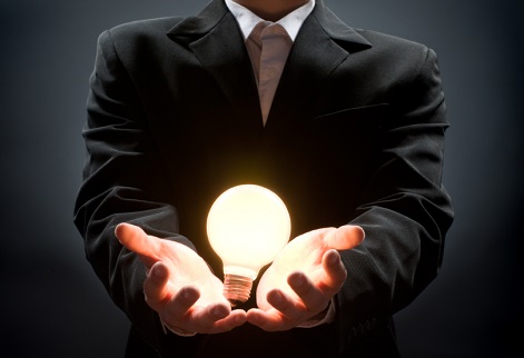 a man pointing to the illuminated bulb